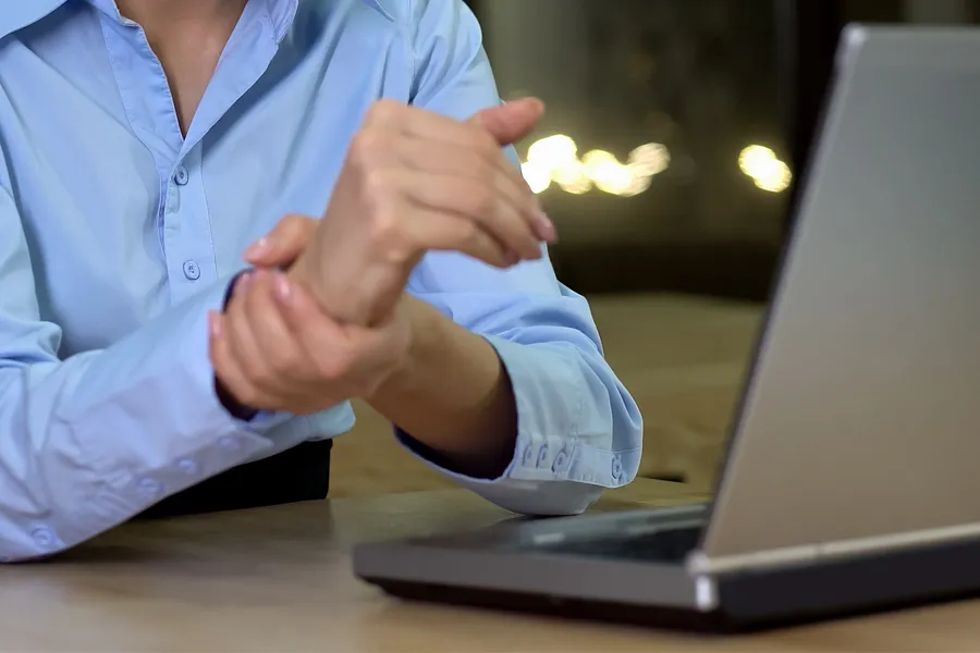 Carpal-Tunnel-Syndrome-Clinic A woman holds her hand in pain. Schedule treatment for carpal tunnel syndrome from Stephen Beyer, DC in Mokena.