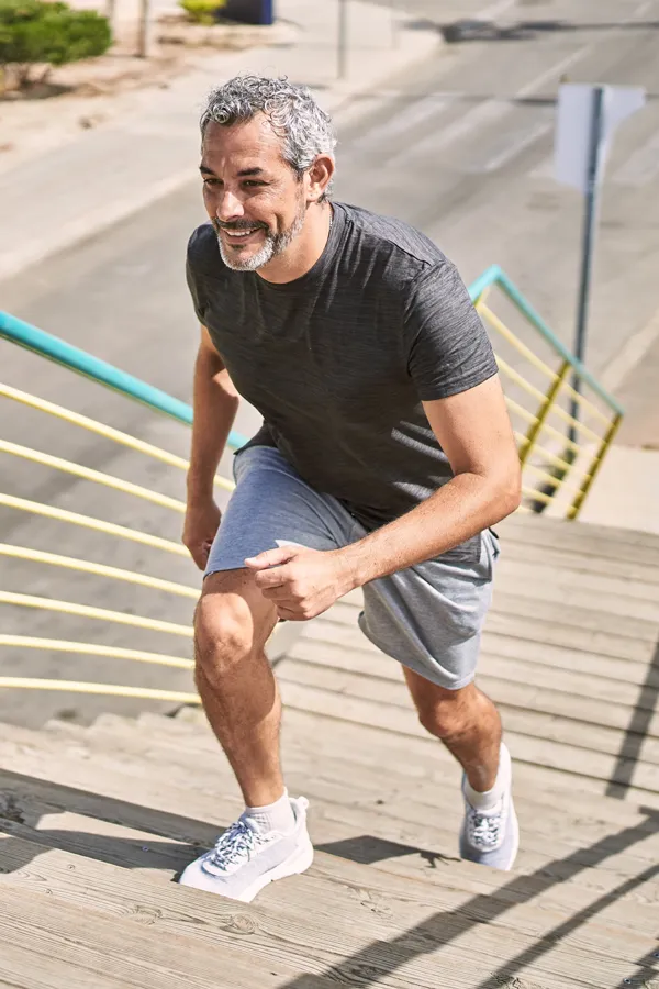 EMSculpt-NEO-for-Joint-Pain-Treatment A man happily jogs up stadium stairs. Get EMSculpt NEO for joint pain treatment from Stephen Beyer, DC in Mokena.