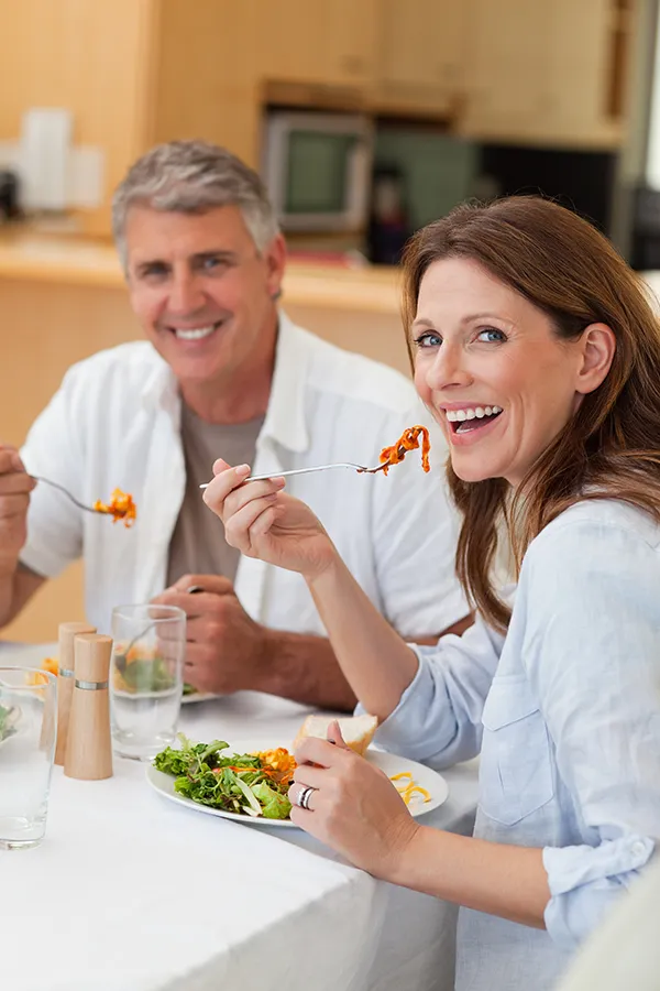 Leaky-Gut-Syndrome-Treatment Improve digestion with Stephen Beyer, DC's Functional Medicine for Leaky Gut Syndrome care in Mokena, featuring a happy couple enjoying a nutritious lunch at home.