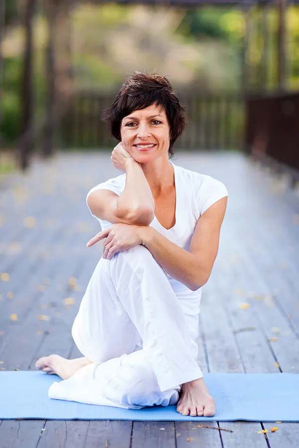 Osteoarthritis-Treatment A woman happily doing yoga. Get osteoarthritis treatment from Stephen Beyer, DC in Mokena.