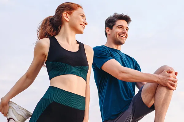 PRP-for-Sports-and-Orthopedics-Clinic A couple in exercise clothes stretching and preparing for a run. Get Platelet Rich Plasma (PRP) treatment for sports and orthopedics from Stephen Beyer, DC in Mokena.
