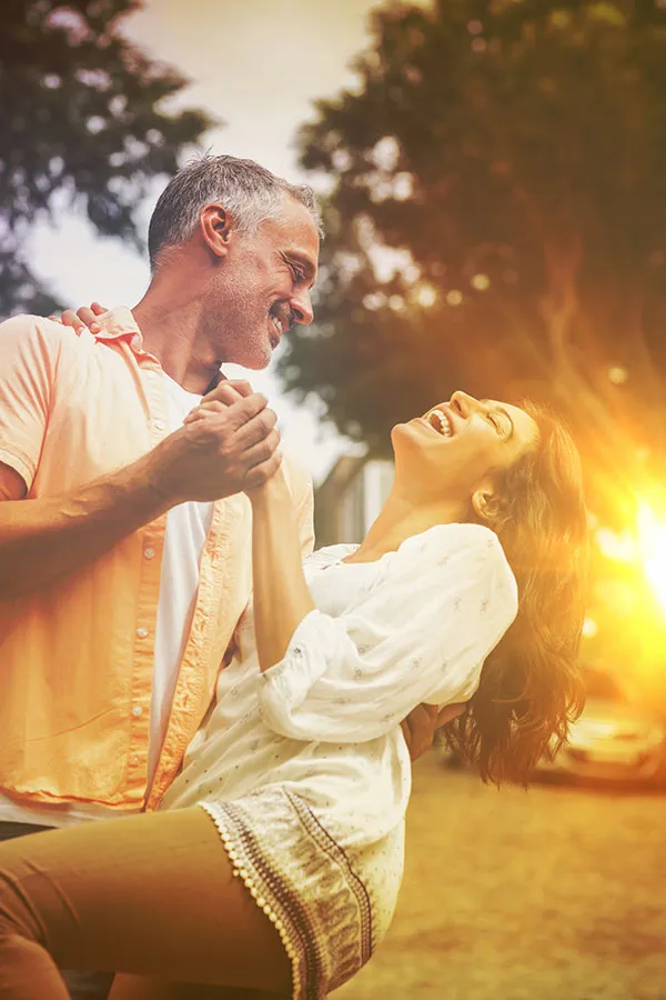 Sciatica-Treatment A middle-aged couple dancing at sunset. Get sciatica treatment from Stephen Beyer, DC in Mokena.
