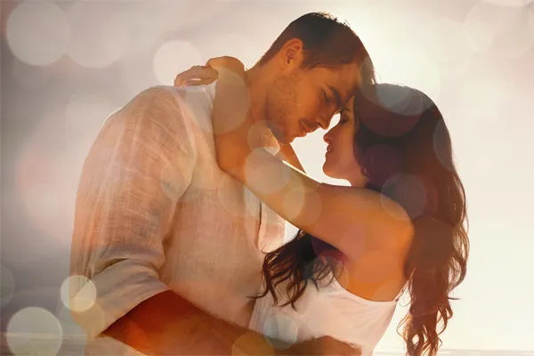 Sexual-Wellness-for-Women-and-Men-Doctor A couple in linen shirts standing in a sparkling light embraces each other with their foreheads touching and eyes closed, happy with their sexual wellness treatments from Stephen Beyer, DC in Mokena.