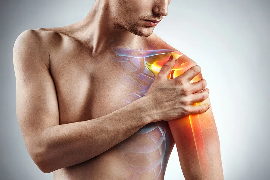 Stem-Cells-for-joint-Pain-Clinic A man holds his shoulder, highlighted in red, in pain. Schedule stem cells for joint pain from Stephen Beyer, DC in Mokena.