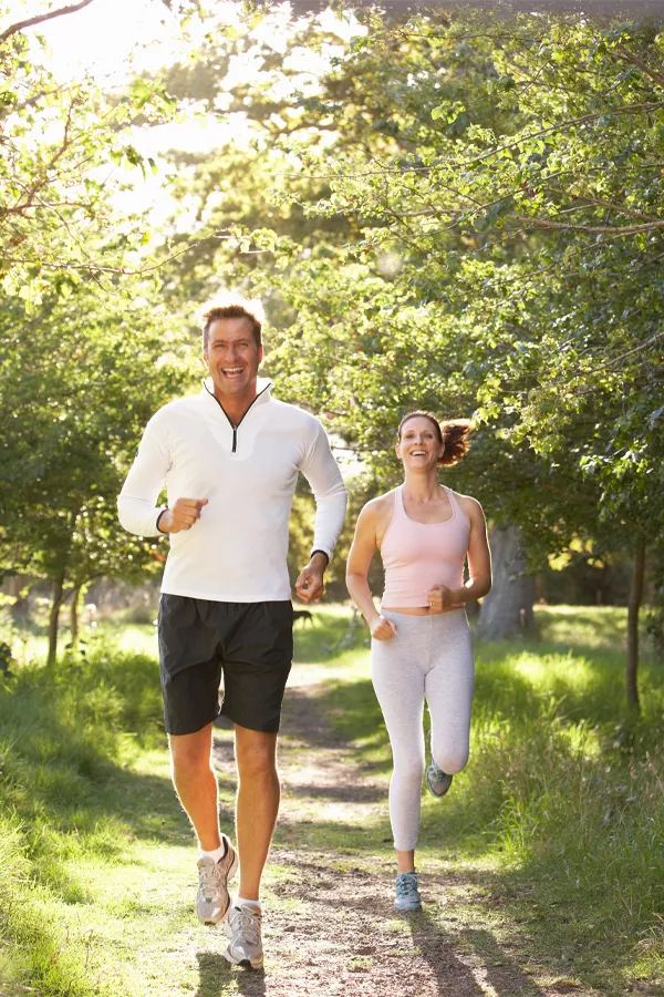 Stemwave-Therapy-Treatment A middle-aged couple jogs happily. Get StemWave therapy for joint pain from Stephen Beyer, DC in Mokena.