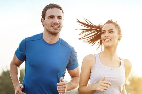 Weight-Loss-Resistance-Doctor A couple happily jogging in the sunlight after receiving effective weight loss resistance care from Stephen Beyer, DC in Mokena.